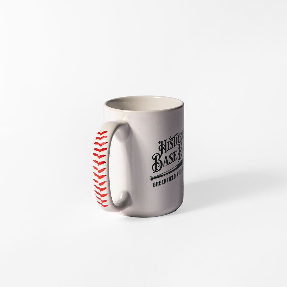 The Greenfield Village Base Ball Club Mug is a white ceramic mug with "History Baseball Greenfield Village" in black and red baseball stitching on the handle—a perfect vintage-style collectible for fans.