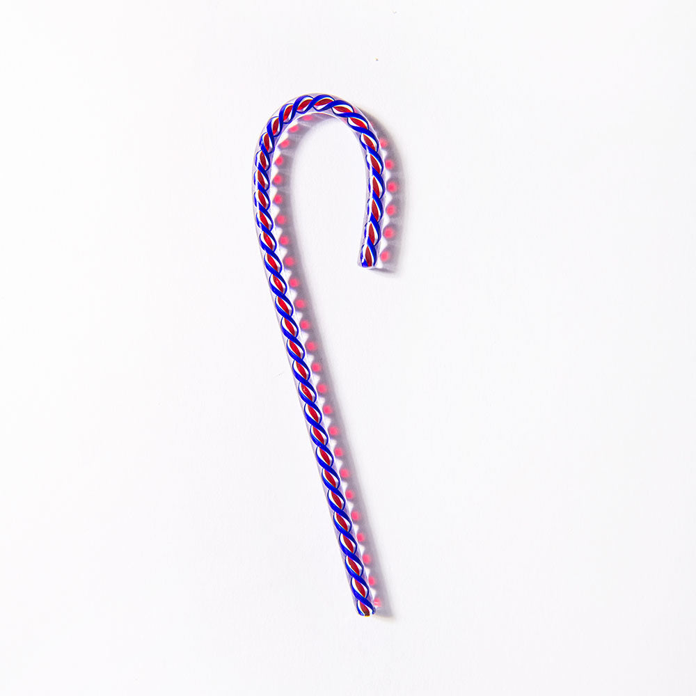 The 2026 Candy Cane, a limited-edition with twisted blue, red, and white stripes, rests on a white background casting a pink shadow—perfect for celebrating America’s 250th anniversary.