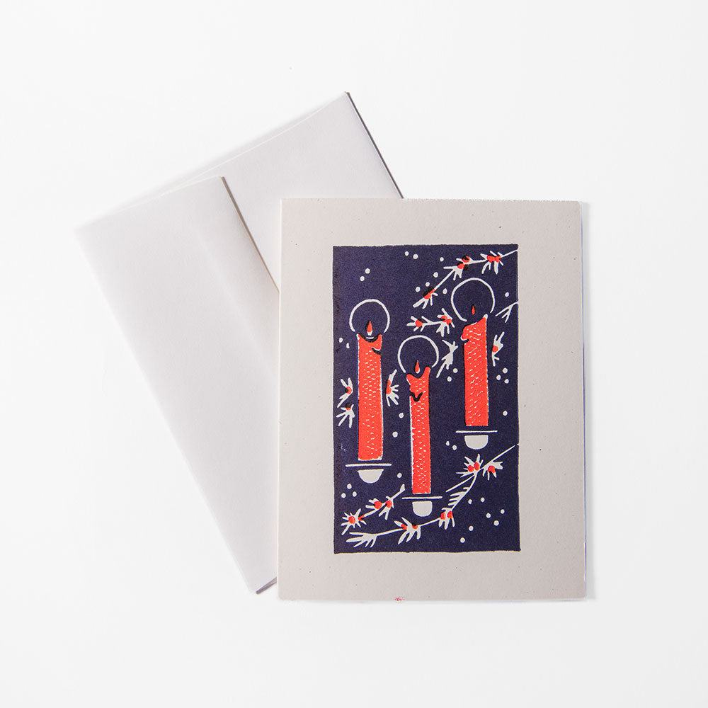 The 2026 Candy Cane Card Set features a handprinted holiday card with three lit red candles surrounded by white and red branches on a dark background, paired with a white envelope.