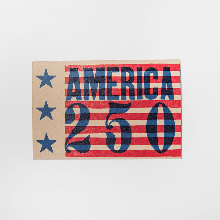 The America 250 Postcard is printed on brown kraft paper with red and white stripes, three blue stars on the left, and bold blue "AMERICA 250" text, commemorating America's 250th anniversary.