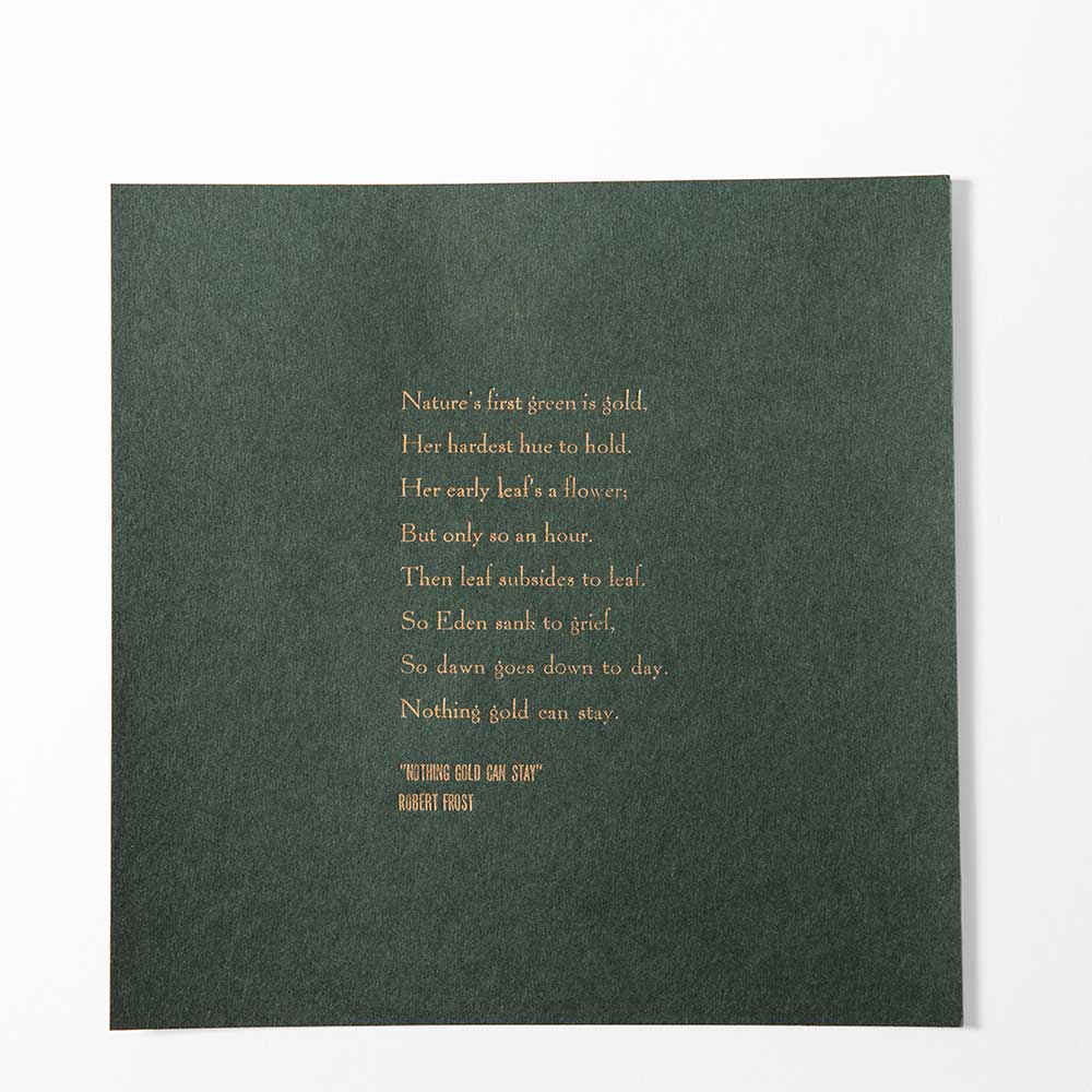 The Frost Quote Poster displays Robert Frost’s poem “Nothing Gold Can Stay” in gold text, centered on dark green paper. This literary wall decor offers a classic, elegant look that stands out in any room.