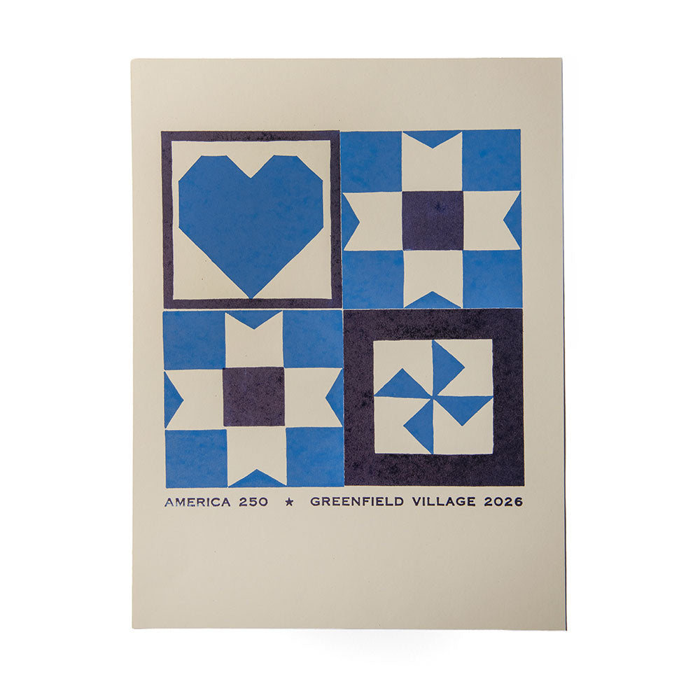 The America 250 Quilt Poster showcases four blue and white quilt block designs with heart and star motifs. The bottom text reads “AMERICA 250 * GREENFIELD VILLAGE 2026” to celebrate America's 250th anniversary.