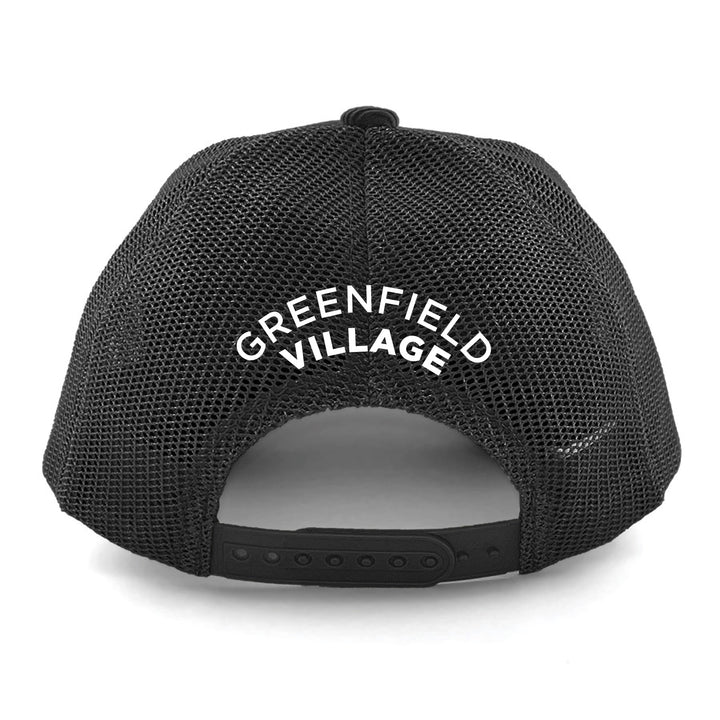 The back view of the Greenfield Village Corduroy Trucker Cap in black mesh features “GREENFIELD VILLAGE” in white, curved text above the adjustable snap closure—a perfect keepsake for any visit to the renowned living history museum.