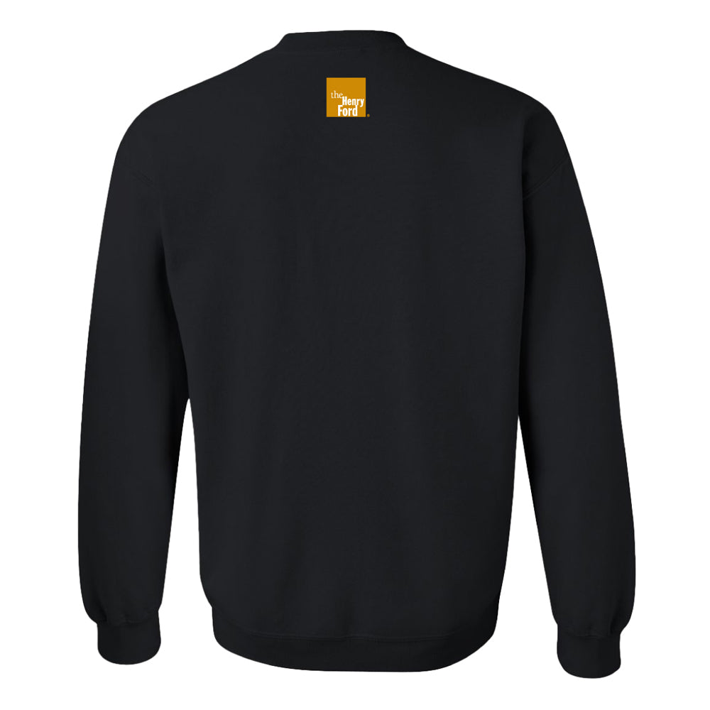 The Henry Ford® Dream Like King Fleece Crew Sweatshirt shown from the back, featuring a small orange square with white "The Henry Ford" text near the neckline.