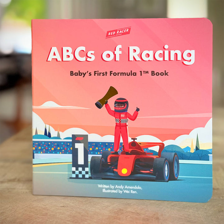 The cover of "ABCs of Racing: Baby's First Formula 1 Board Book" shows a cartoon racecar driver holding a trophy beside a red racecar and winner’s podium.