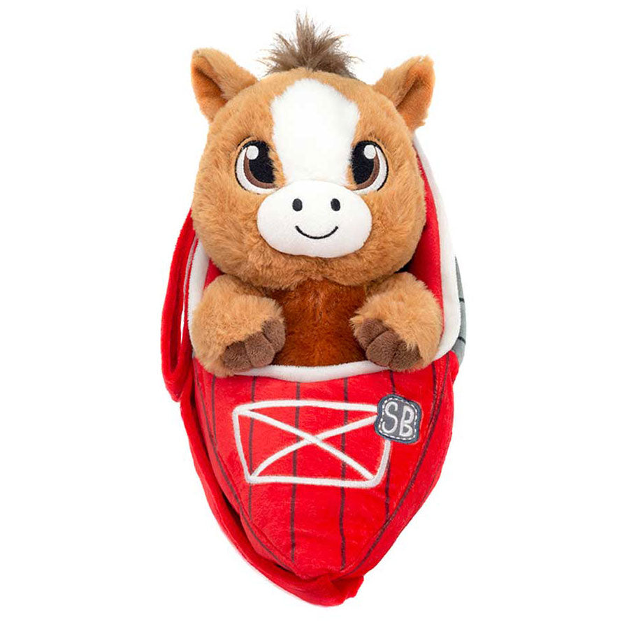 The Swaddle Babies Cuddle Horse is a cute brown and white plush horse with big eyes, sitting in a red slipper decorated with a white letter and “SB” stitching—an adorable farm animal toy for cuddling babies in comfort.