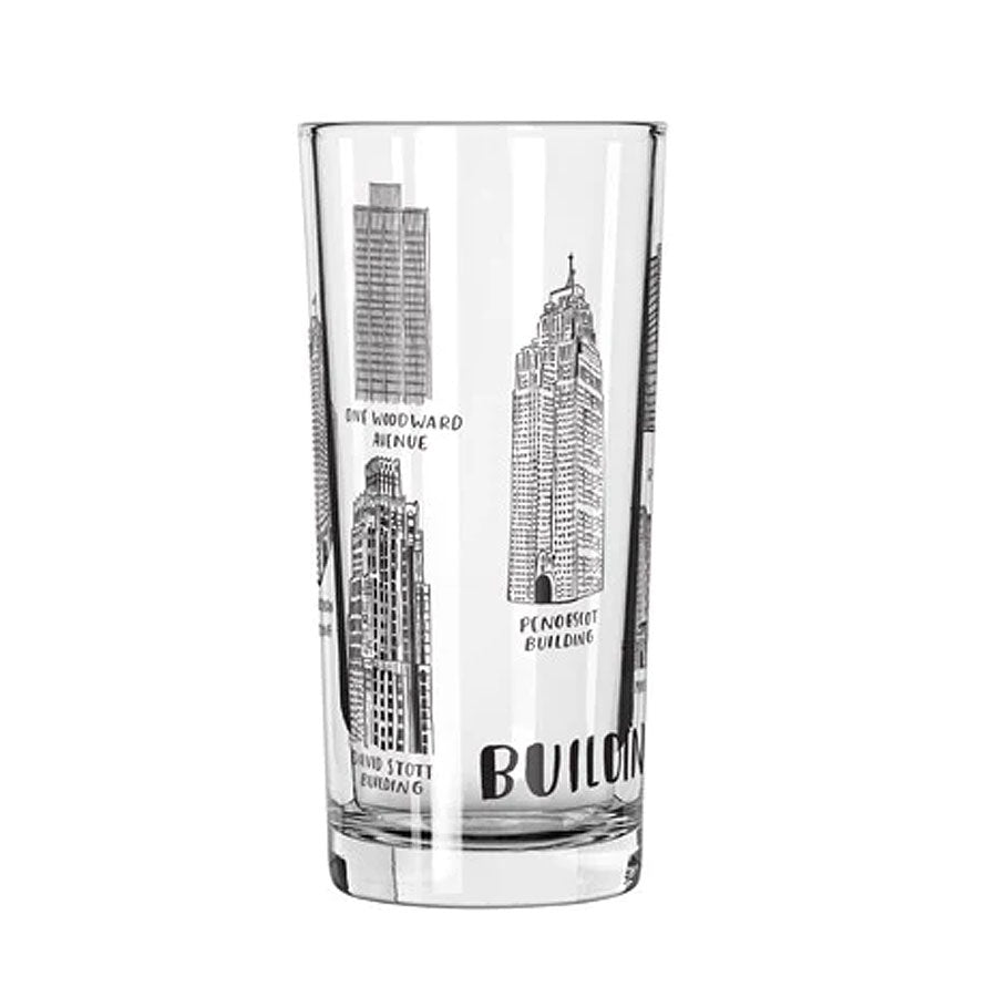 The Buildings of Detroit 12oz Glass features black-and-white illustrations of iconic Detroit buildings, each labeled with names such as “Penobscot Building” and “One Woodward Avenue.”.