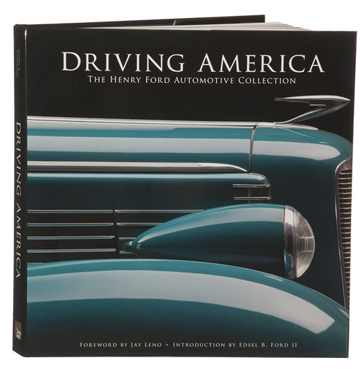 The image shows the cover of "Driving America: The Henry Ford Automotive Collection - Hardcover Edition," featuring a close-up of a vintage blue car, with a foreword by Jay Leno and an introduction by Edsel B. Ford II.