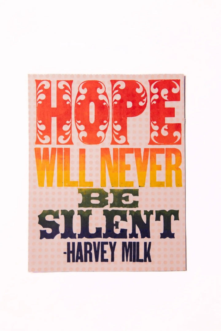 The Milk Quote Poster features bold, colorful text: HOPE WILL NEVER BE SILENT – HARVEY MILK. HOPE and SILENT stand out in a vibrant rainbow gradient, echoing the iconic spirit of Harvey Milk's message.