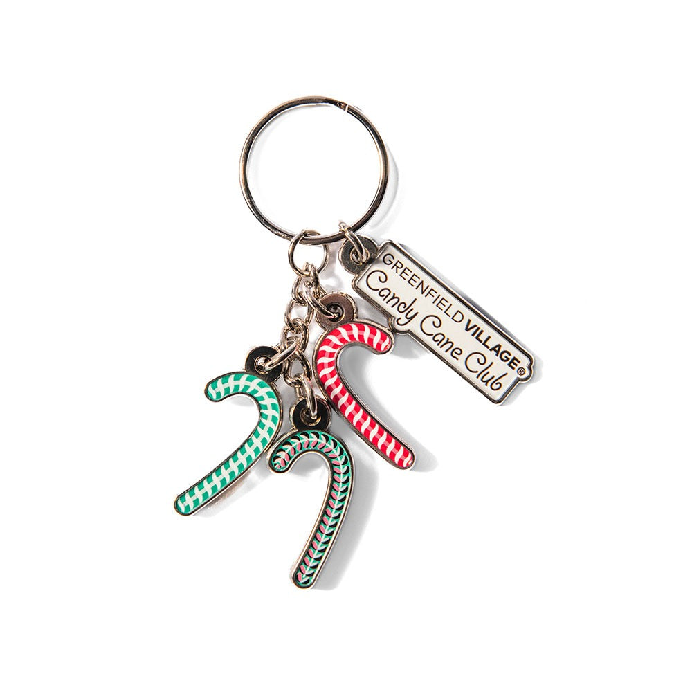 The Henry Ford® Greenfield Village Candy Cane Charm Keychain features three festive candy cane charms—green/white, red/white, and red/green—plus a tag reading "Greenfield Village Candy Cane Club," making it a perfect holiday keepsake.