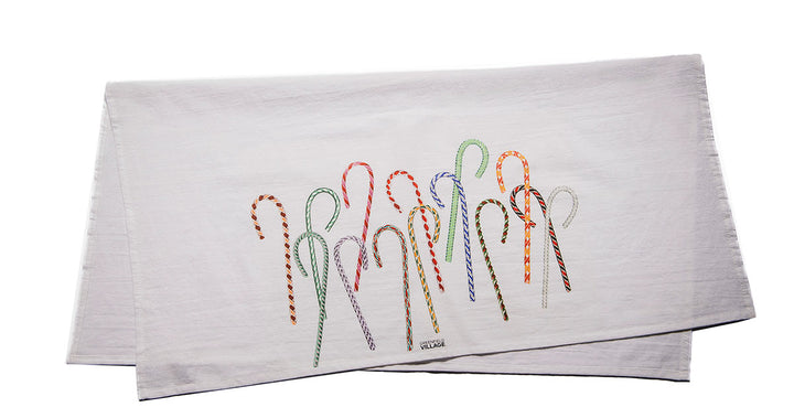 The Henry Ford® Greenfield Village Candy Cane Tea Towel is a white cloth napkin adorned with colorful embroidered candy canes in various festive designs.