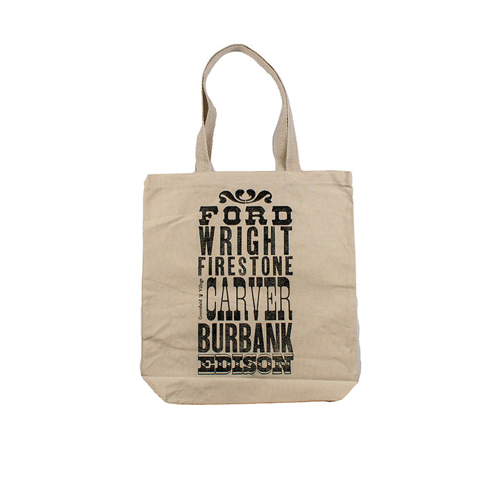 The Innovators Tote is a natural canvas bag featuring black vertical text of names—Ford, Wright, Firestone, Carver, Burbank, Edison. Inspired by Greenfield Village, it has two handles and is shown on a white background.