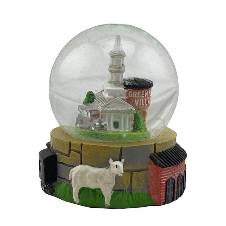 The Greenfield Village Waterglobe features a miniature white church with a steeple, a water tower labeled Greeneville, and a white goat outside a brick building—ideal as historic village decor for any display.
