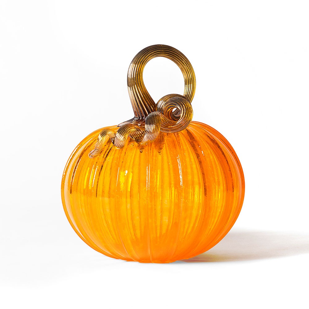 The Large Glass Pumpkin - Saffron features an orange, ribbed body and a curly, translucent brown stem, reminiscent of hand-blown pumpkins from Greenfield Village, shown against a white background.