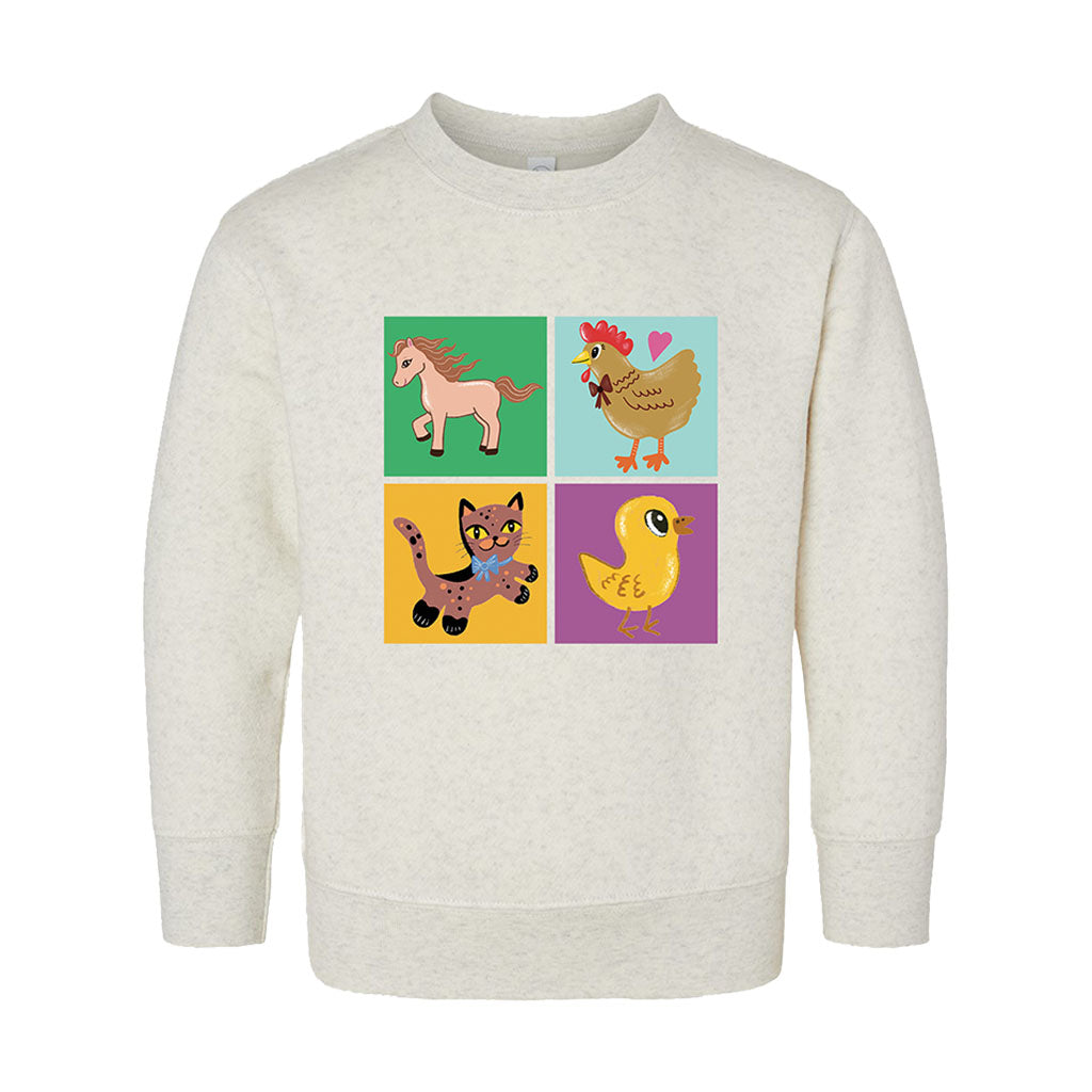 The Greenfield Village Barn Toddler Sweatshirt is a light crew with a four-square design showing cartoon horse, chicken, cat, and duck—each in its own bright square inspired by playful Humberto Cruz artwork.
