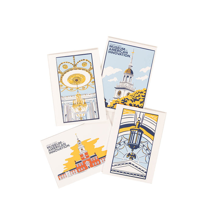 The Henry Ford Museum Building Note Card Set includes four illustrated postcards with architectural landmarks and chandeliers in yellow, blue, and orange tones; two cards feature Museum of American Innovation text. Cards are displayed in an overlapping layout.