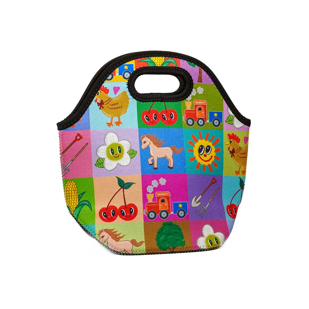 The Greenfield Village Icons Lunch Tote features playful illustrations—cherries, a horse, and a smiling sun—set against a vibrant patchwork background inspired by Humberto Cruz artwork.