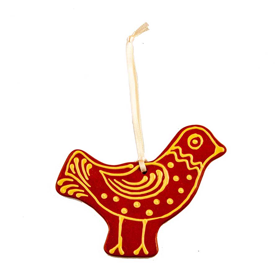 The Redware Partridge Ornament is a handcrafted ceramic ornament from Greenfield Village Pottery. Shaped like a red bird with yellow patterns and a cream hanging loop, it’s perfect as a unique holiday gift.