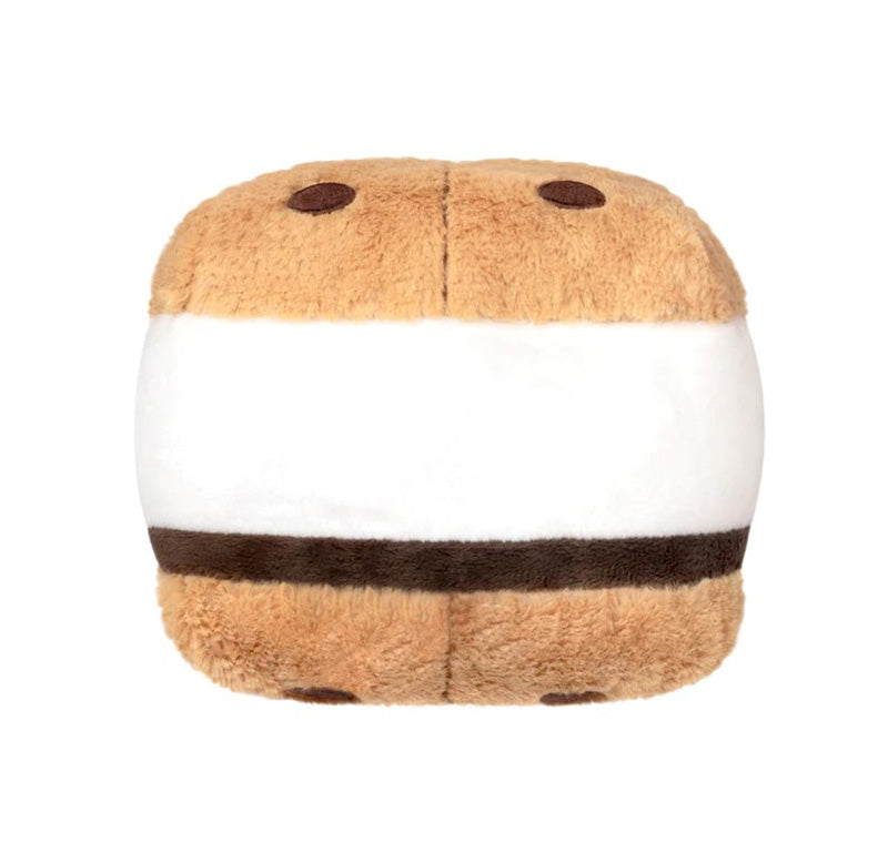 The Plush Squishable S'more Snacker is a soft, fuzzy toy shaped like a s'more, featuring light brown graham cracker sides, a white marshmallow center, and a dark brown chocolate layer.