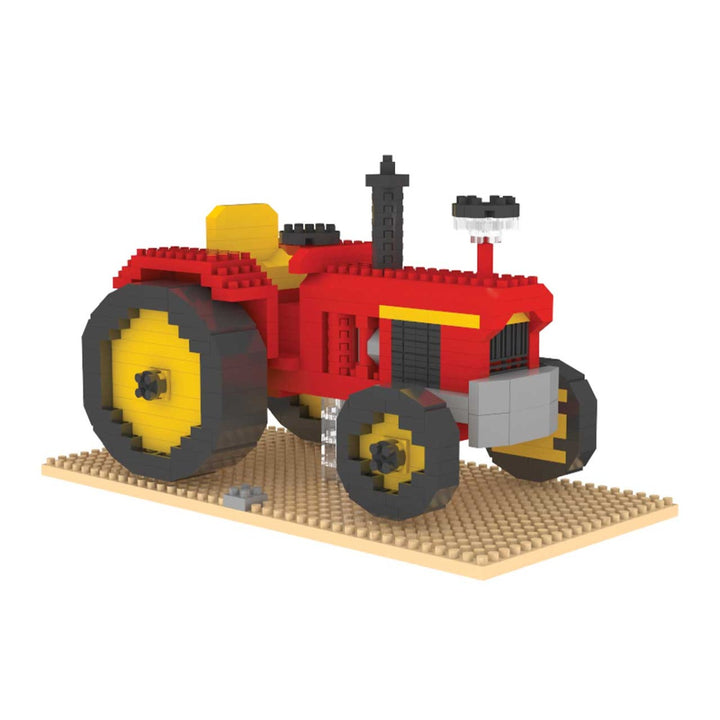 The Mini Building Block - Tractor is a red and yellow model farm tractor built from mini blocks, set on a tan baseplate with large rear wheels, small front wheels, and a black smokestack—ideal for assembly enthusiasts.