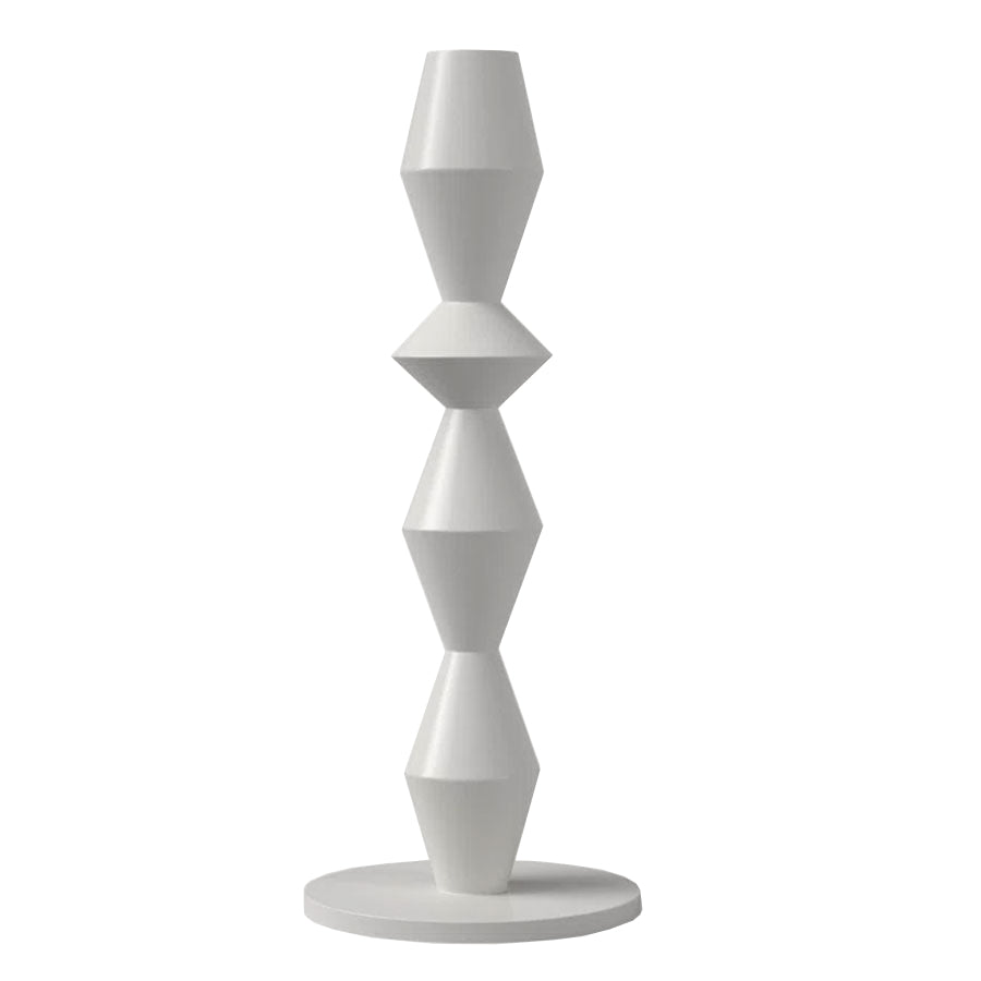 The Vector Candle Holder is a modern white sculpture with four stacked geometric shapes and angular facets on a round base, ideal for displaying taper candles.