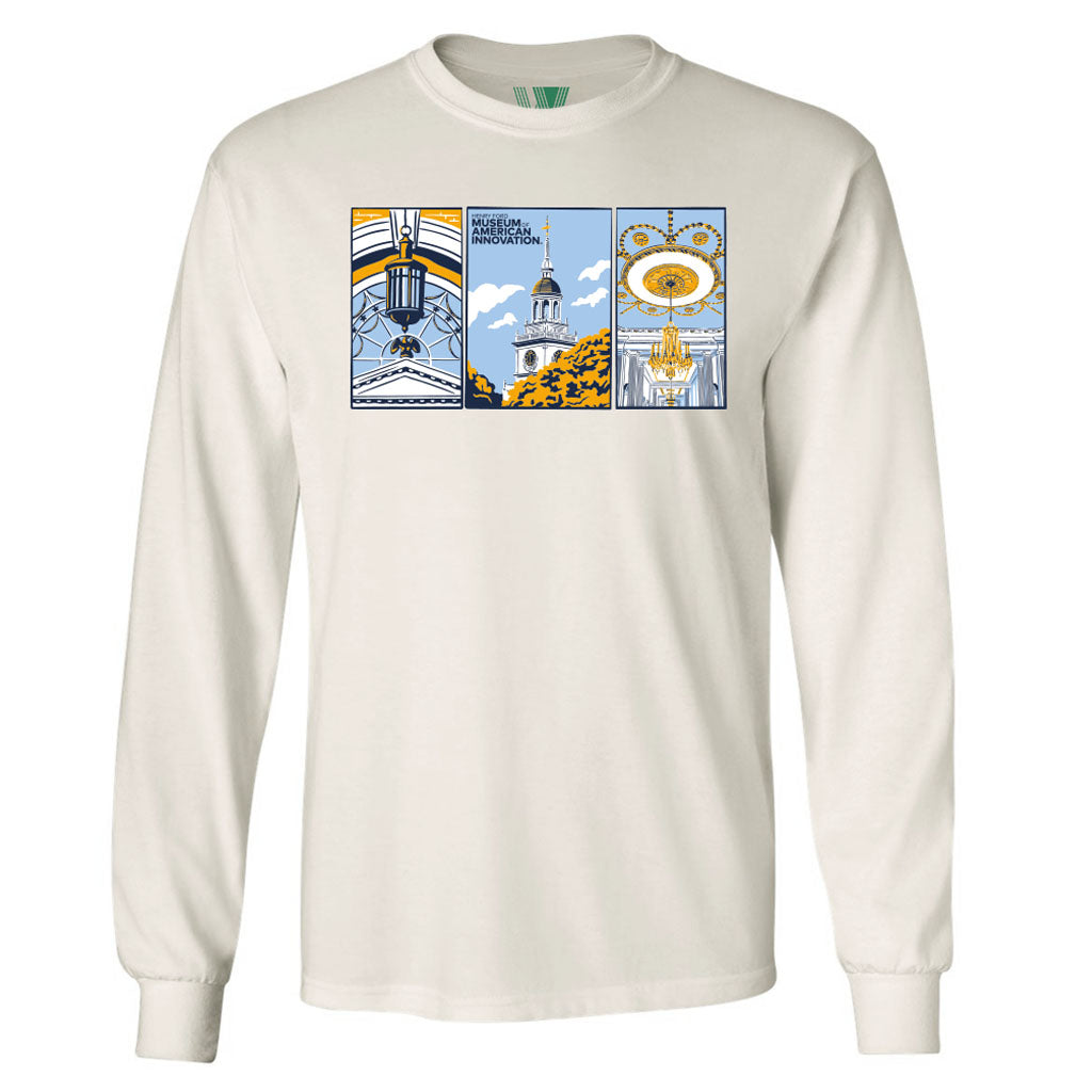 The Henry Ford Museum Architecture Long Sleeve T-Shirt is an organic cotton, cream-colored shirt with three-panel graphic art in blue, gold, and white accents and “Science, Art, Innovation” at the top of the center panel.