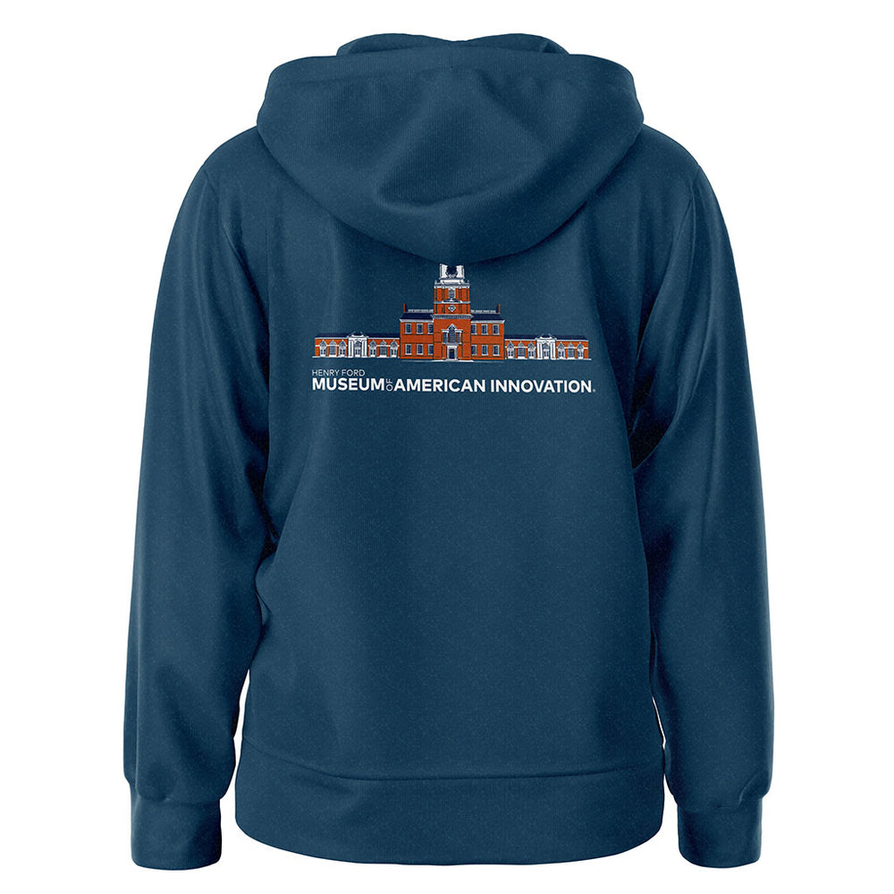 The Henry Ford Museum Architecture Zip-Up Hooded Sweatshirt in navy features a back graphic of a red brick building and "MUSEUM: AMERICAN INNOVATION." text, celebrating responsibly made apparel inspired by the museum itself.