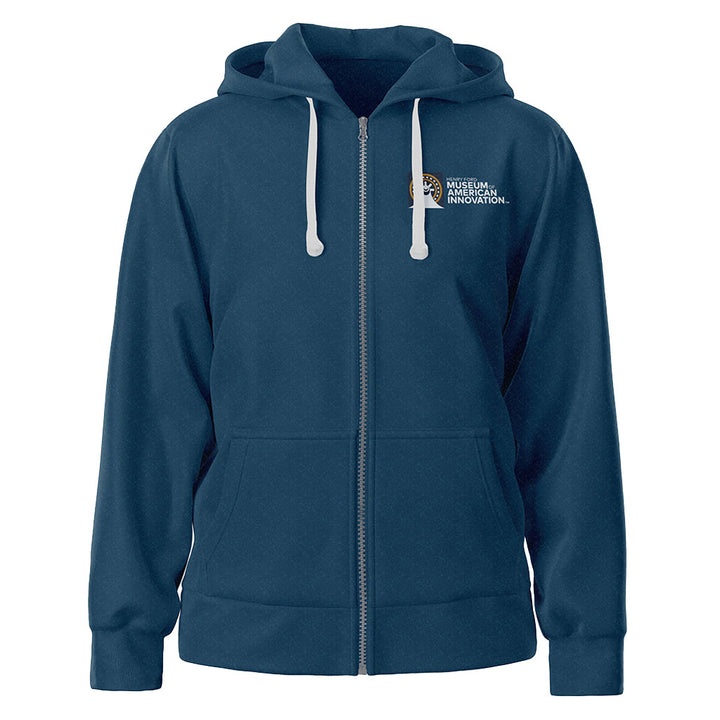 A navy blue zip-up hoodie with white drawstrings, front pockets, and a small white "Museum of American Innovation" logo on the left chest. Inspired by museum architecture, it’s The Henry Ford Museum Architecture Zip-Up Hooded Sweatshirt.