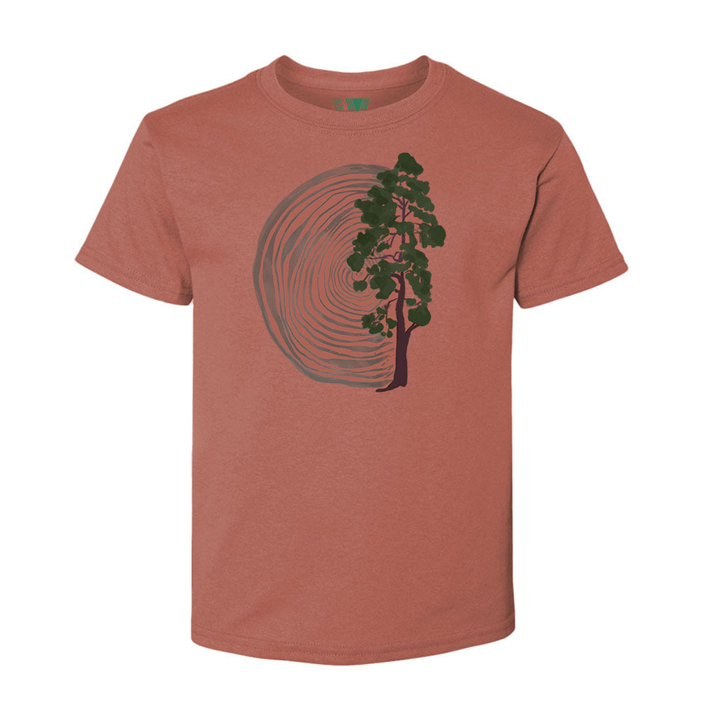 The Wood and Tree Youth T-Shirt is an eco-friendly, rust-colored organic cotton tee featuring a front tree design with concentric rings that symbolize tree rings.